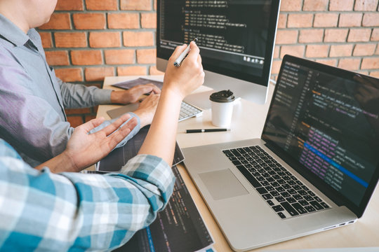 Professional Developer programmer cooperation meeting and brainstorming and programming in website working a software outsourcing and coding technology, writing codes and database