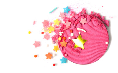 A broken pink eye shadow make up palette isolated on a white background. Fantasy star confetti. Top view, flat lay.
