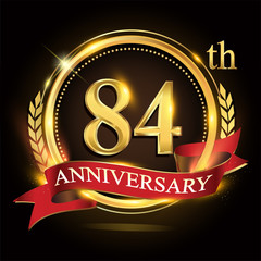 84th golden anniversary logo, with shiny ring and red ribbon, laurel wreath isolated on black background, vector design for birthday celebration.