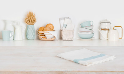 Dish cloth on wooden table over defocused kitchen counter background