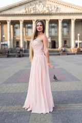 Obraz premium Young attractive girl in summer dress posing outdoor