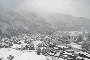 Snowing at country small village in the valley, winter season.