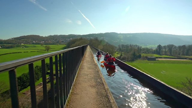 A Kayak, canoe instructor takes his clients over the famous Pontcysyllte Aqueduct on the Llangollen canal situated in North Wales, outdoors extreme sports
