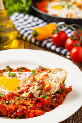 Shakshouka, dish of eggs poached in a sauce of tomatoes, chili peppers, onions