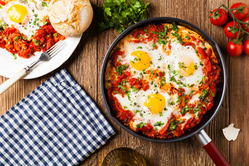 Shakshouka, dish of eggs poached in a sauce of tomatoes, chili peppers, onions