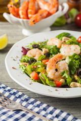 Shrimp salad with tomato, olives and cashew nuts.