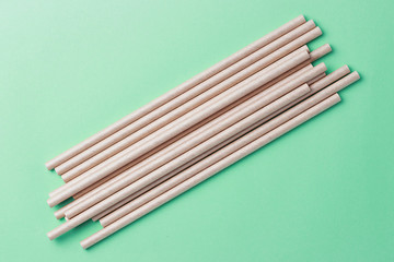ecological bamboo straws for drinking on a green background, close-up