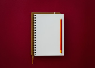Blank white notepad with pencil isolated on red paper background. - 260956469