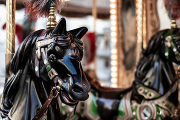 Bright horses carousel detail on a merry-go-round