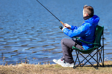 Fishing. Fisherman catches fish on lake