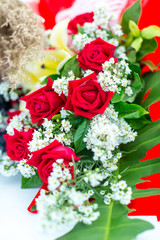 Valentines day background. Beautiful bouquet of roses on wooden table . Luxury bouquet made of red roses in flower shop Valentines Bouquet of red roses.  Rose bouquet. Soft focus of a Rose .