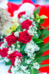 Valentines day background. Beautiful bouquet of roses on wooden table . Luxury bouquet made of red roses in flower shop Valentines Bouquet of red roses.  Rose bouquet. Soft focus of a Rose .
