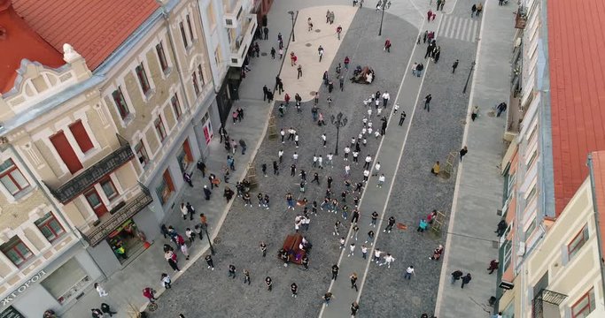 Aerial view: Flashmob performed by children in the central square. 4k. 50fps