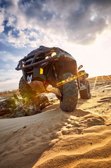 Racing in the sand on a four-wheel drive quad. © Bondariev Volodymyr.