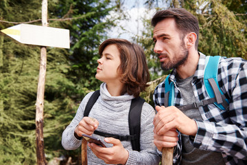 Father and son choosing the best footpath for hiking trip