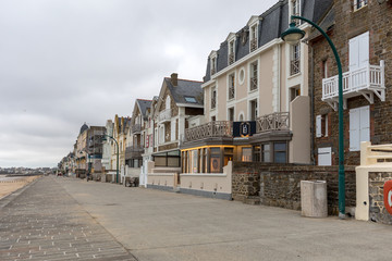 Fototapeta na wymiar Front view of traditional granite houses along the promenade in Saint-Malo