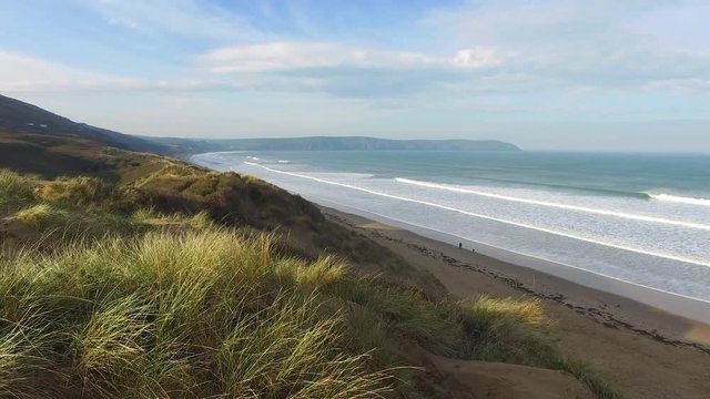 Wide angle shot with crane up over dunes at Woolacombe in North Devon, England, UK