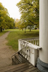 Porch and wooden balustrade in an old Russian manor, park view.