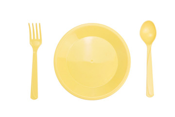 Top view Yellow plastic dish fork spoon isolated on white background