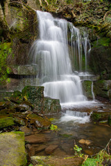 Fototapeta na wymiar Harmby waterfall in woodland.