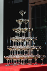 Big champagne tower on a red table