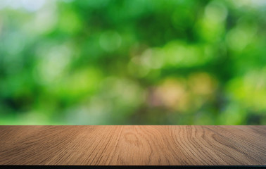 Empty dark wooden table in front of abstract blurred bokeh background of restaurant . can be used for display or montage your products.Mock up for space.