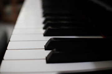 Naklejka premium Piano keyboard background with selective focus.