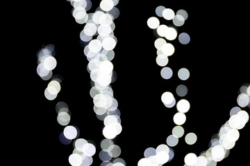 Abstract light bokeh as background defocused and blurred many round light on black background