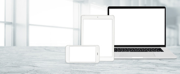 Banner of multi device technology for responsive web design - laptop , digital tablet and smartphone in various orientation at the office (copy space).