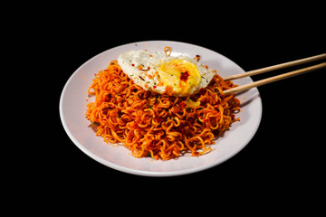 fried noodle and fried egg on a plate 