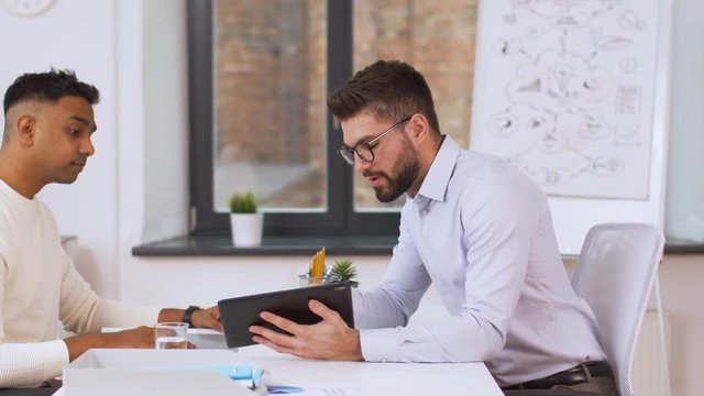 job, business and employment concept - employer or hr manager having interview with indian male employee at office