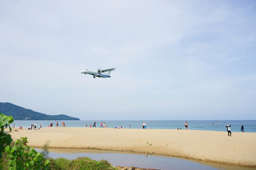 Fototapeta na wymiar Extreme Landing aircraft above the beautiful Mai khao beach near Phuket Airport. Watching planes landing with a beautiful beach as a background. Excellent photo playground for tourist.