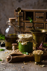 Homemade italian sauce pesto in small glass jar 
