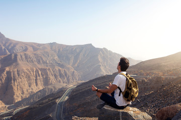 Fototapeta premium Man meditating on the mountain top