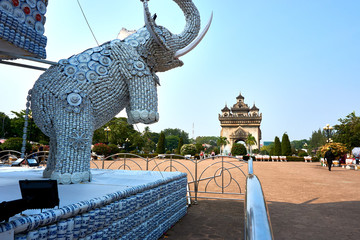 Elephant statue out of cups and plates next to Patuxai Victory Monument The One Attractive Landmark of Vientiane City of Laos.