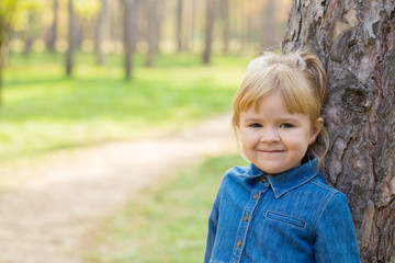 Fototapeta premium portrait of happy little girl with smile on face on sunny day