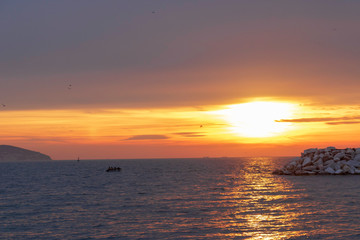 People in private boat sailing at sunset in Istanbul