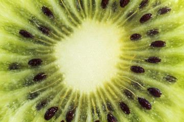Bright juicy green cut of kiwi fruit close-up. High-quality image is suitable for topics: healthy...