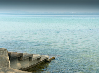 lake shore nature abstract view with concrete stairs leading into the water