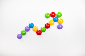 A pointing arrow made from children's toys. Multicolored figures for games