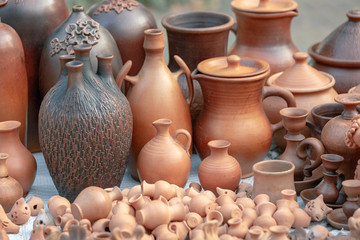 Fototapeta na wymiar Various ceramic products from clay are presented. There are comfortable and functional items with different shape for food and drink from clay. Outdoor photos.
