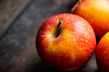 Close-up apples on the rustic wooden background. Selective focus. Shallow depth of field. 