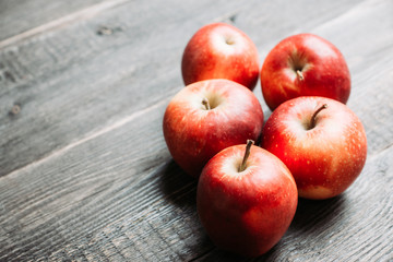 Close-up apples on the rustic wooden background. Selective focus. Shallow depth of field. 