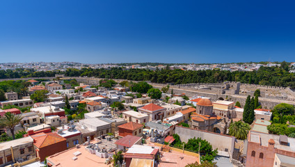 Fototapeta na wymiar Panoramic view of the Rhodes medieval old city surrounded by ancient stone defensive walls, with the new town and Acropolis in the background. Popular summer holiday destination in the Greece.