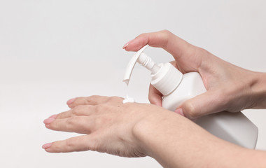 Woman hands with cream. Woman applying moisturizer cream on her hands and soft skin. Health and beauty concept. Front view. 