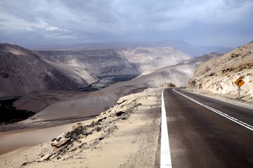 Highway through Cordillera de la Sal (Salt mountains) with blurred horizon, Atacama desert