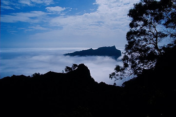 Silhouettes of mountains decks among clouds