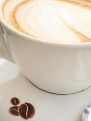 Cup of cappuccino on the table, coffee shop background.