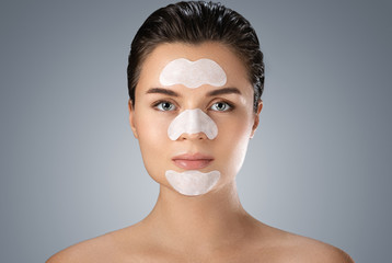 Beautiful woman with a cleansing pore strips on her face