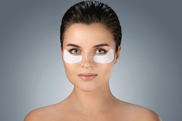 Woman with hydrating eye patches under her eyes o